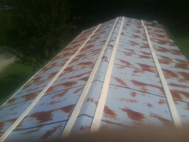 Rusted metal roof panels with new wood purlins before replacement — Storm Damage Roof Repair in Edgewood by Roofing Brothers